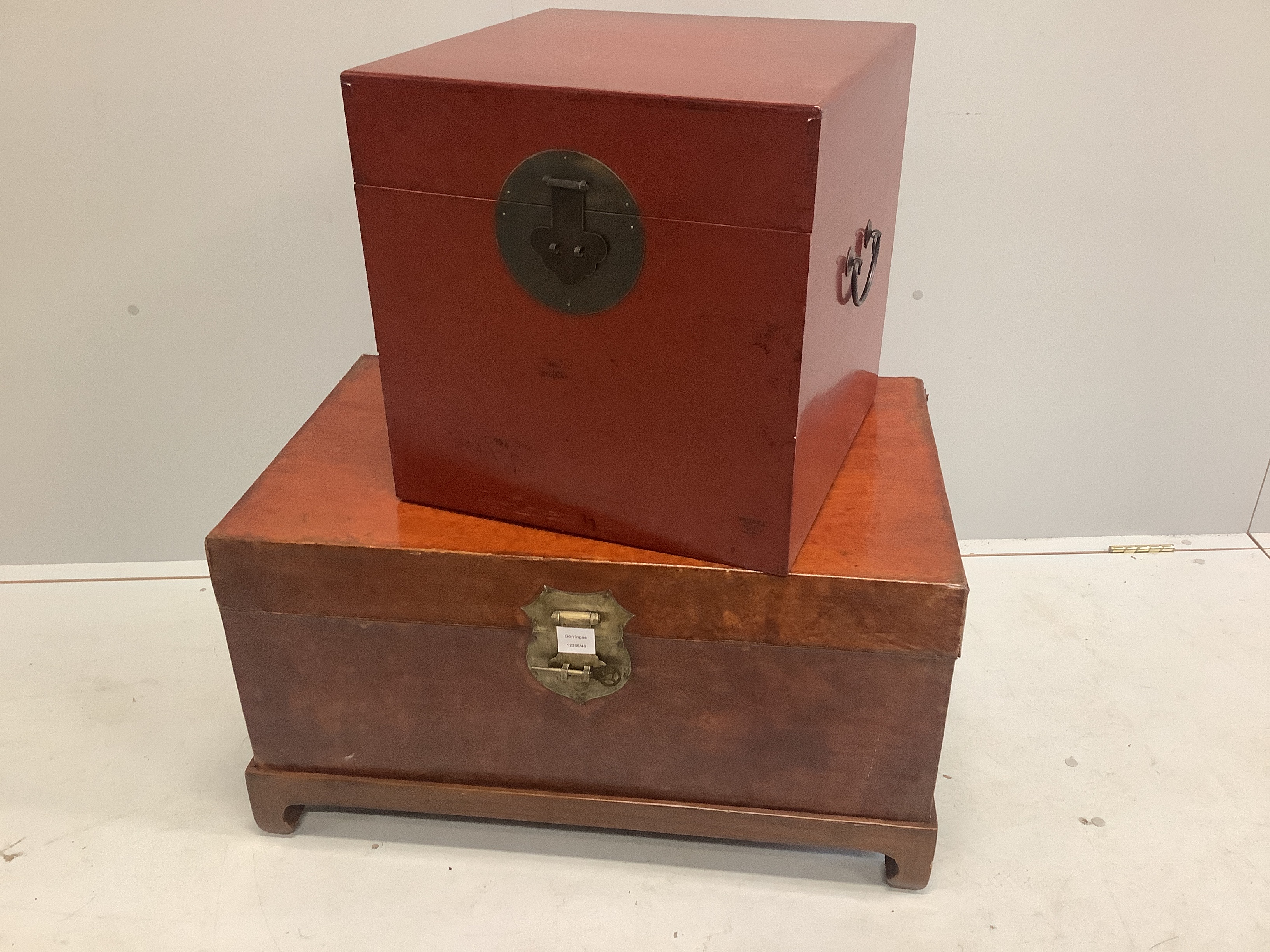 A Chinese leather bound trunk on stand and a small Chinese lacquer trunk, larger width 79cm, depth 49cm, height 44cm